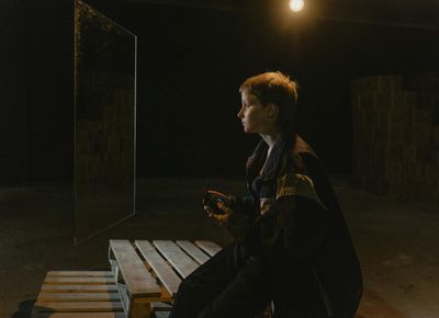 Person meditating in a quiet, minimalist room.